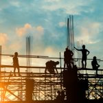Silhouette of engineer and construction team working safely on scaffolding on high rise building. over blurred background sunset pastel for industry background with Light fair